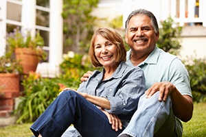 Smiling older couple with dental implants in Fort Lauderdale outdoors