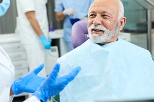 Happy man talking to dentist after dental implants in Fort Lauderdale
